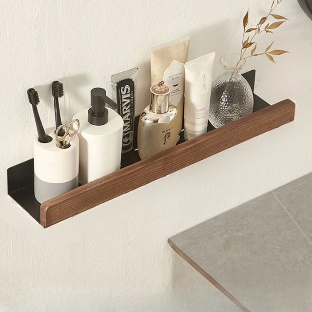 Bathroom wall shelf with raised edge for storage