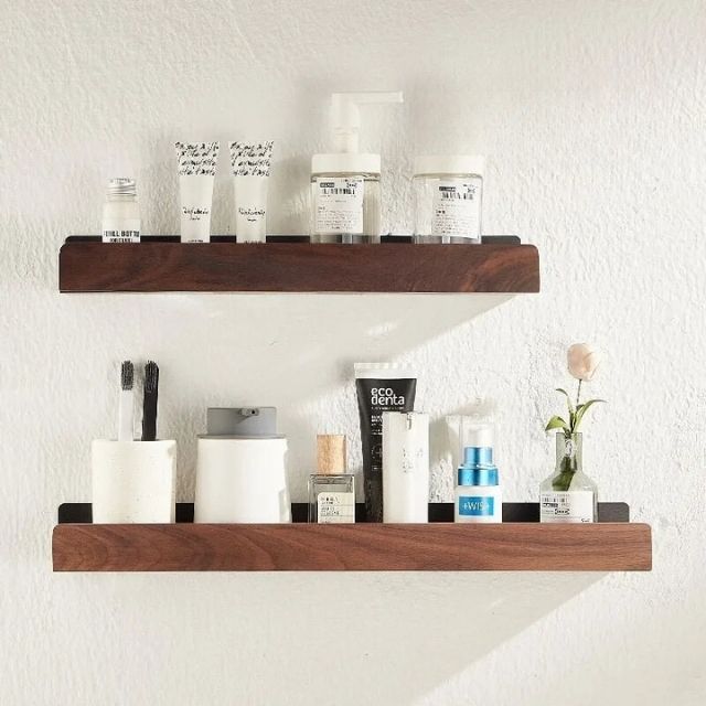 Bathroom wall shelf with raised edge for storage