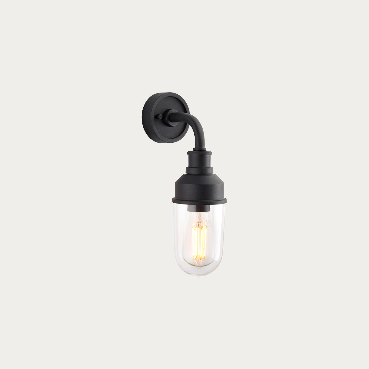 Zwarte wandlamp voor de slaapkamer met transparante kap